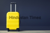 Travel,Bag,Against,The,Wall.,Yellow,Suitcase.