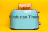 Bright,,Fun,Breakfast.,Cyan,Color,Toaster,On,A,Yellow,Background