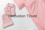 Pink,Pajamas,Folded,Bed,,Blanket,And,Pillow,In,Bedroom,Of