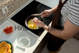 Close-up,Of,Unrecognizable,Man,In,Apron,Cracking,Egg,With,Knife