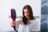 Woman,Using,A,Hot,Brush,To,Straighten,Her,Hair