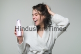 Woman,Touching,Her,Hair.,Woman,Hold,Bottle,Shampoo,And,Conditioner.