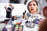 Young,Beautiful,Woman,Making,Make-up,Near,Mirror,sitting,At,The,Desk