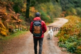 A,Hiker,In,A,Red,Coat,And,Brown,Backpack,Walking