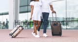 Unrecognizable,Black,Couple,Walking,With,Suitcases,Outdoors,After,Arriving,To